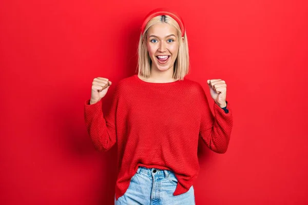 Beautiful Blonde Woman Wearing Casual Red Sweater Celebrating Surprised Amazed — Stockfoto