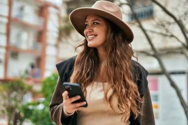 Şehirde akıllı telefon kullanan genç İspanyol turist kadın..