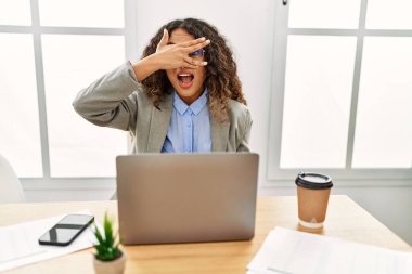 Güzel bir İspanyol iş kadını ofisinde oturmuş dizüstü bilgisayarla çalışıyor. Şok olmuş bir şekilde yüzünü ve gözlerini kapatıyor. Utanmış bir ifadeyle parmaklarından bakıyor.. 