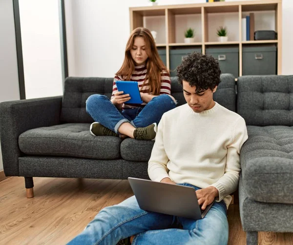 Young Couple Serious Expression Using Laptop Touchpad Sitting Sofa Home — Foto Stock