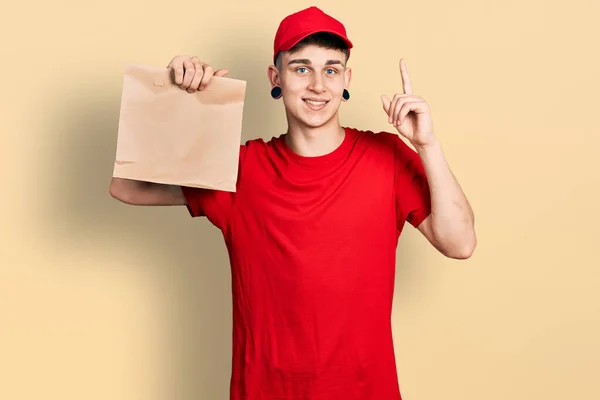 Young Caucasian Boy Ears Dilation Holding Take Away Paper Bag — 스톡 사진