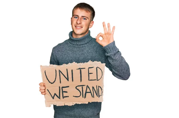 Young Blond Man Holding United Stand Banner Doing Sign Fingers — Fotografia de Stock