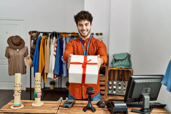 Jovem Lojista Hispânico Homem Sorrindo Feliz Segurando Presente Loja Roupas — Fotografia de Stock