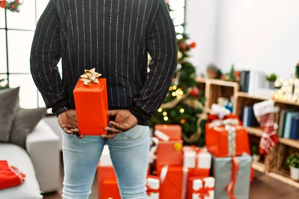 Young African American Man Holding Gift His Back Standing Christmas — стокове фото
