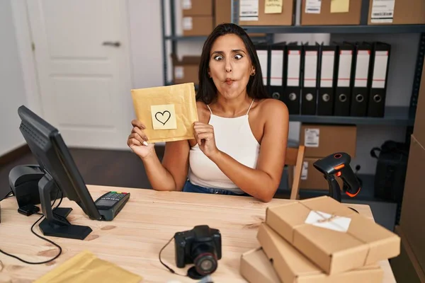 Young Hispanic Woman Working Small Business Ecommerce Making Fish Face — Stok fotoğraf