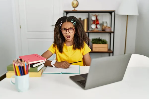 Young African American Girl Doing Homework Home Shock Face Looking — Stok fotoğraf