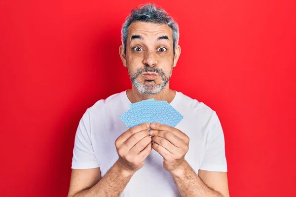 Handsome Middle Age Man Grey Hair Covering Face Cards Puffing — Foto Stock