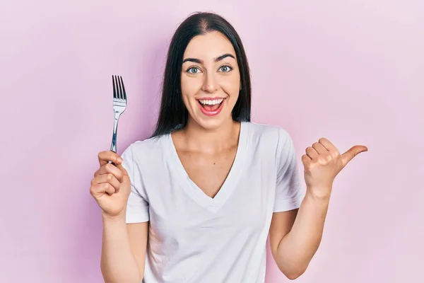 Beautiful Woman Blue Eyes Holding One Silver Fork Pointing Thumb —  Fotos de Stock