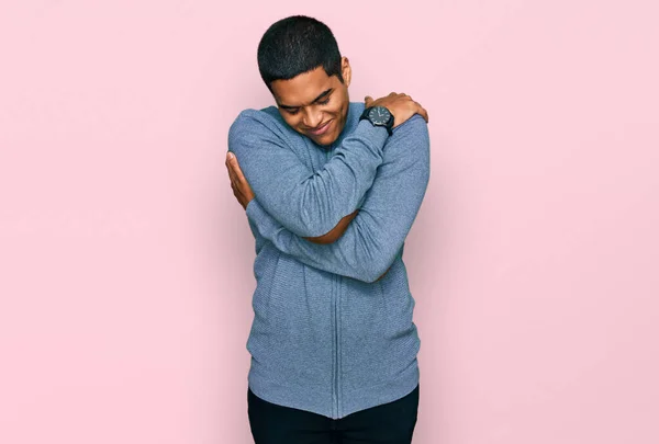 Young Handsome Hispanic Man Wearing Casual Sweatshirt Hugging Oneself Happy — Stok fotoğraf