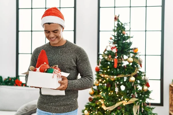 Young Hispanic Man Smiling Confident Holding Box Christmas Decoration Home —  Fotos de Stock