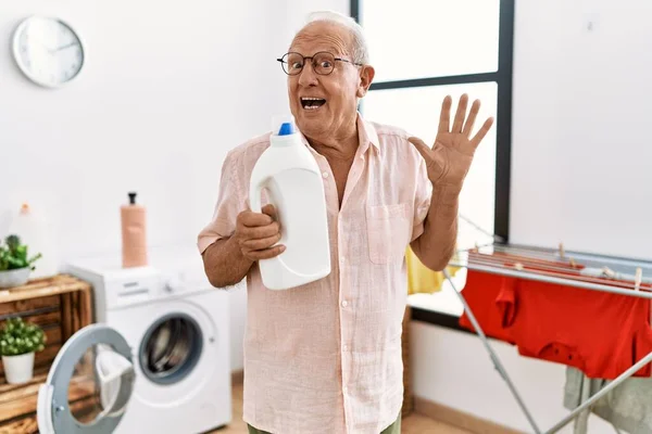 Senior Man Holding Detergent Bottle Laundry Room Screaming Proud Celebrating — Foto de Stock