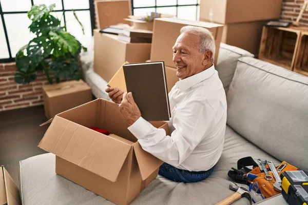 Senior Man Smiling Confident Unboxing Package New Home — Photo