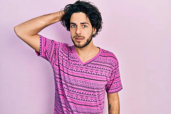 Handsome Hispanic Man Wearing Casual Pink Shirt Confuse Wonder Question — Fotografia de Stock