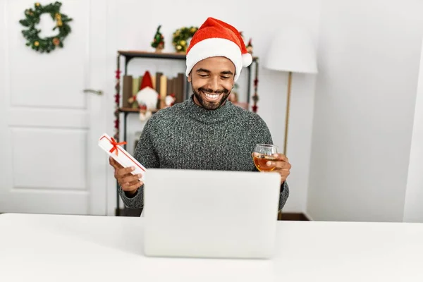 Young African American Man Holding Christmas Gift Using Laptop Drinking — Stock Photo, Image