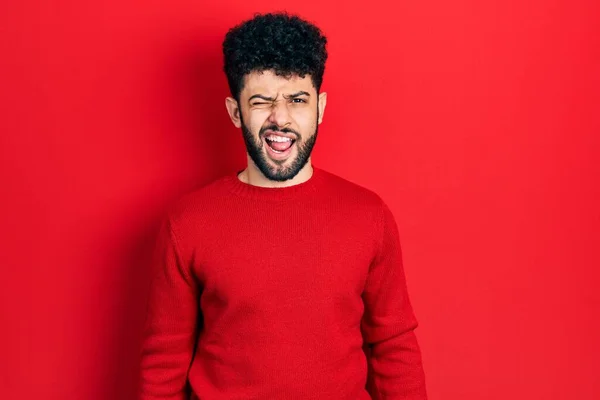 Young Arab Man Beard Wearing Casual Red Sweater Winking Looking — Stock Fotó