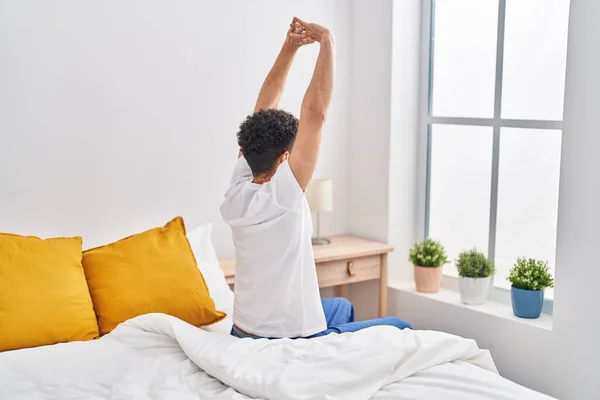 Young Arab Man Waking Stretching Arms Bedroom — Stockfoto