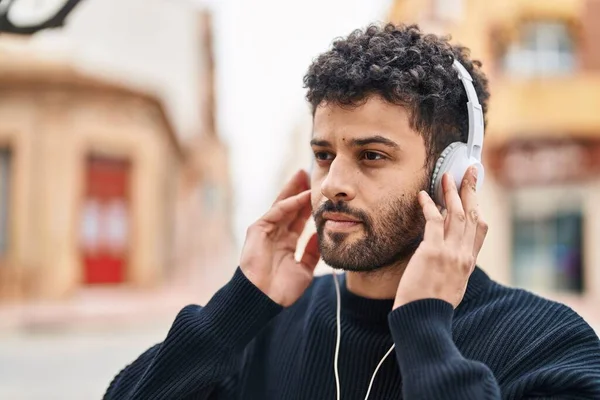 Young Arab Man Listening Music Relaxed Expression Street — Stockfoto