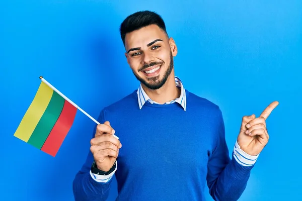 Young Hispanic Man Beard Holding Lithuania Flag Smiling Happy Pointing —  Fotos de Stock