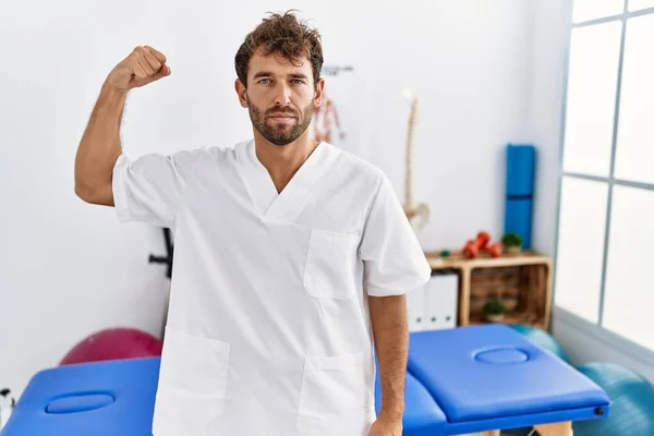 Young Handsome Physiotherapist Man Working Pain Recovery Clinic Strong Person — Φωτογραφία Αρχείου