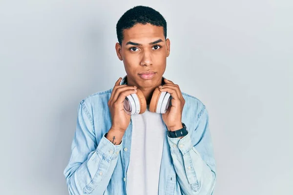 Young African American Guy Listening Music Using Headphones Depressed Worry — Stock Photo, Image