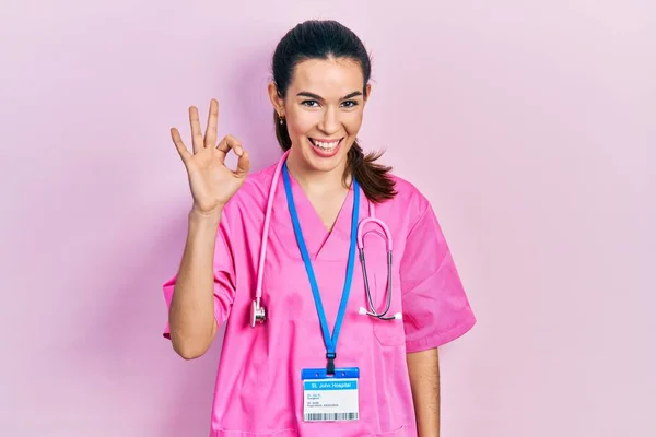 Doktor Üniforması Giyen Esmer Kadın Steteskop Gülümsüyor Parmaklarıyla Tamam Işareti — Stok fotoğraf