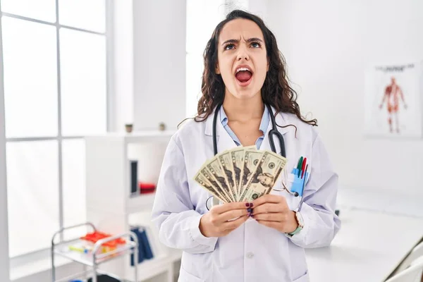 Young Doctor Woman Holding Money Angry Mad Screaming Frustrated Furious — 图库照片