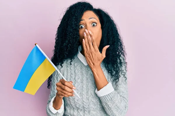 Middle Age African American Woman Holding Ukraine Flag Covering Mouth — Φωτογραφία Αρχείου