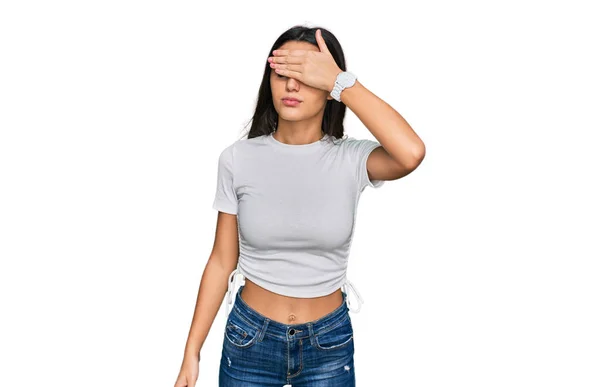 Young Hispanic Girl Wearing Casual White Shirt Covering Eyes Hand — Stock Photo, Image