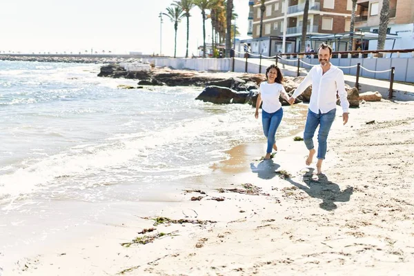 Middle Age Hispanic Couple Smiling Happy Walking Hands Together Beach — Stock fotografie