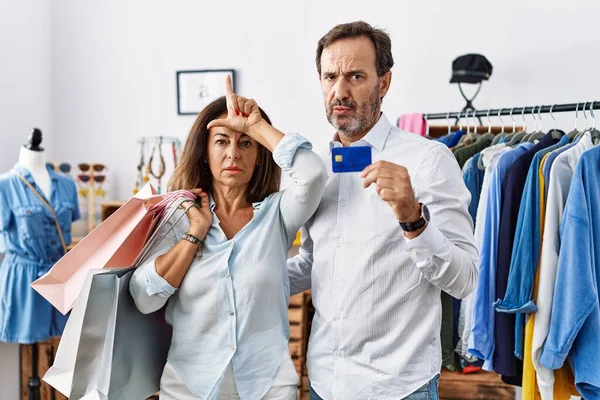 Hispanic Middle Age Couple Holding Shopping Bags Credit Card Making — Stock fotografie