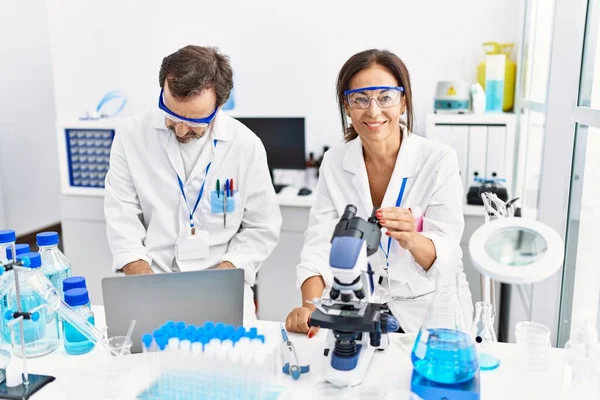 Middle Age Man Woman Partners Wearing Scientist Uniform Using Laptop — Stock Photo, Image
