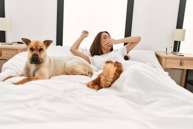 Genç İspanyol kadın uyandığında yatak odasında köpeklerle birlikte kollarını esnetiyordu.