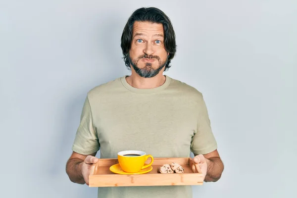 Middle Age Caucasian Man Holding Breakfast Tray Cookies Coffee Puffing — Stockfoto