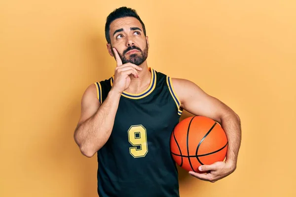 Handsome Hispanic Man Beard Holding Basketball Ball Serious Face Thinking — Stok fotoğraf