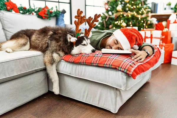 Young Hispanic Man Sleeping Lying Sofa Dog Christmas Tree Home — Stok fotoğraf