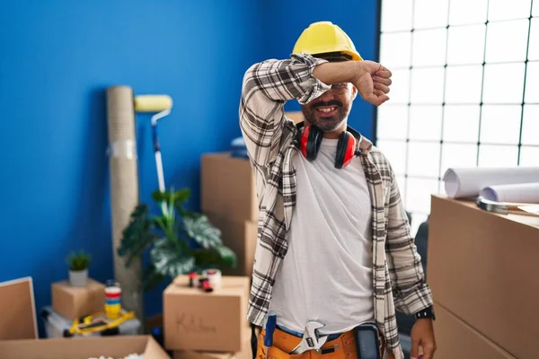 Young Hispanic Man Beard Working Home Renovation Covering Eyes Arm — Stockfoto