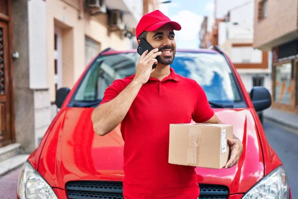 Young Hispanic Man Courier Talking Smartphone Holding Package Street — Foto de Stock