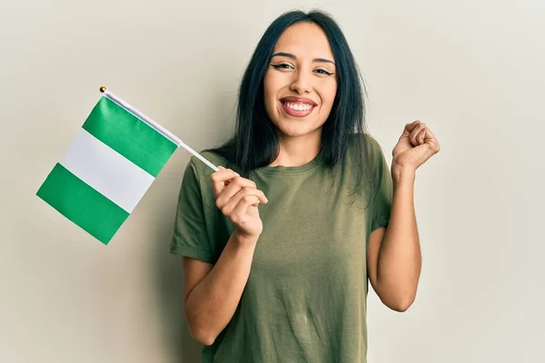 Young Hispanic Girl Holding Nigeria Flag Screaming Proud Celebrating Victory — Fotografia de Stock