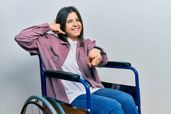 Young Brunette Woman Sitting Wheelchair Smiling Doing Talking Telephone Gesture — Foto de Stock