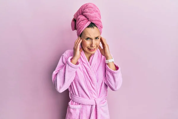 Young Blonde Woman Wearing Shower Towel Cap Bathrobe Covering Ears — стоковое фото