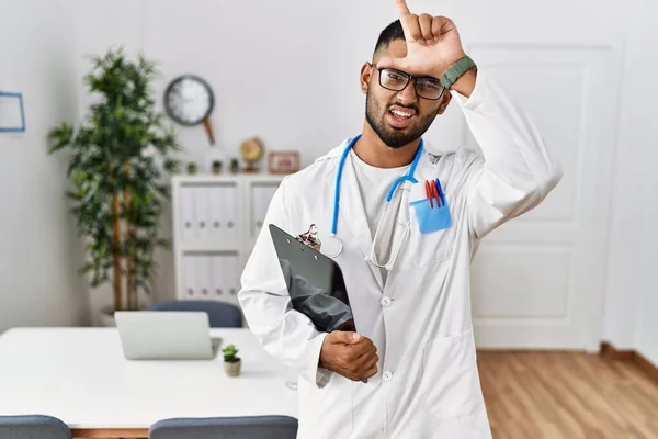 Young Indian Man Wearing Doctor Uniform Stethoscope Making Fun People — Stockfoto