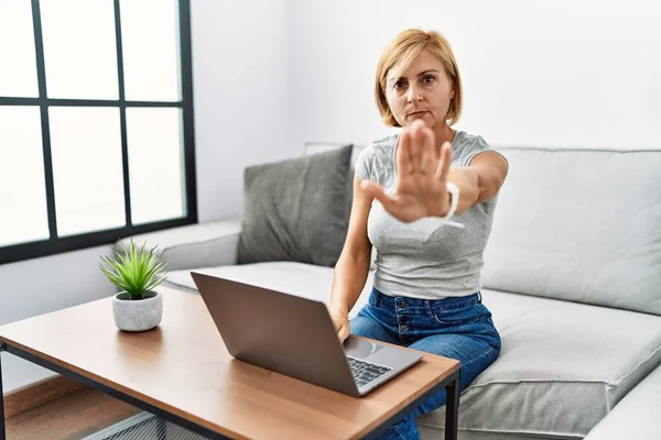 Middle Age Blonde Woman Using Laptop Home Doing Stop Sing — Stockfoto