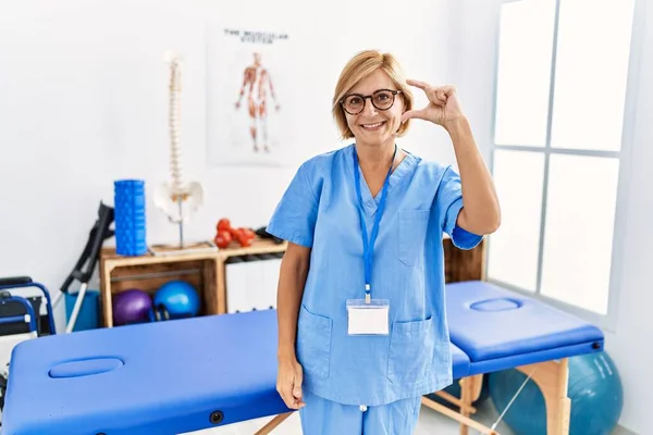 Middle Age Blonde Woman Working Pain Recovery Clinic Smiling Confident — Foto de Stock