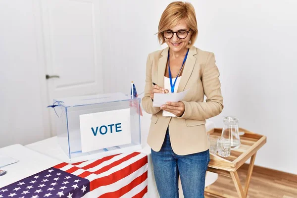 Middle Age Blonde Woman Smiling Confident Writing Vote Electoral College — Foto Stock