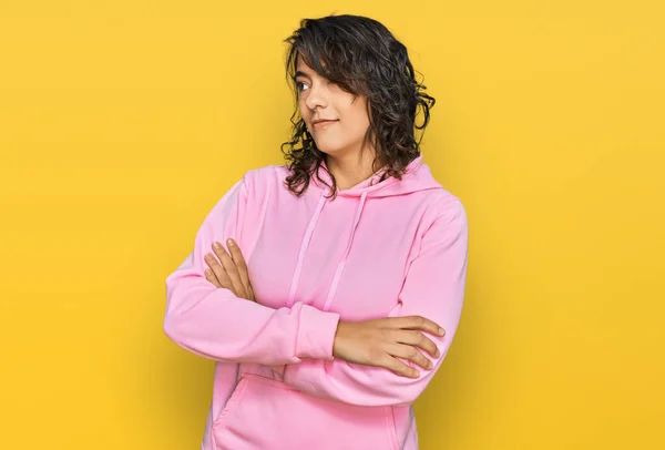 Young Hispanic Woman Wearing Casual Sweatshirt Looking Side Arms Crossed — Stock fotografie