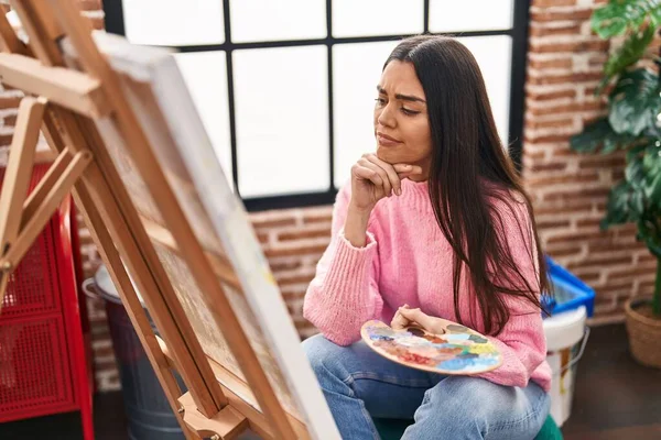 Young Hispanic Woman Doubt Expression Looking Draw Art Studio — Zdjęcie stockowe