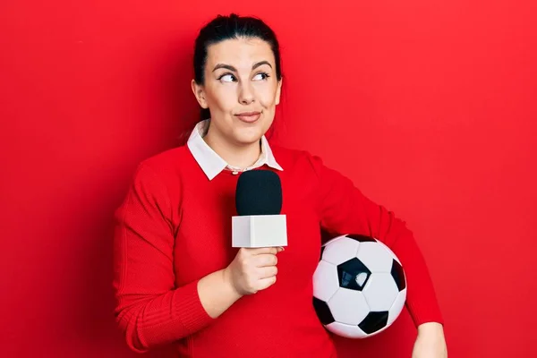 Young Hispanic Woman Holding Reporter Microphone Soccer Ball Smiling Looking — ストック写真