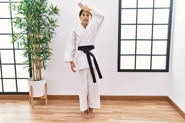 Young Hispanic Girl Wearing Karate Kimono Black Belt Surprised Hand — 스톡 사진