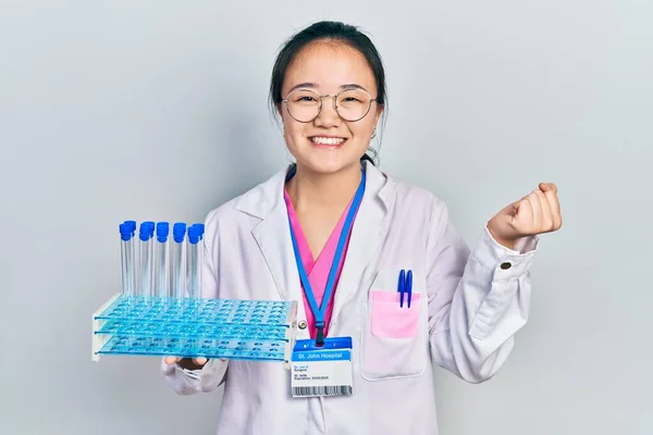 Młoda Chińska Dziewczyna Mundurze Naukowca Trzyma Probówkę Krzycząc Dumny Świętując — Zdjęcie stockowe