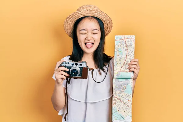 Young Chinese Girl Holding City Map Vintage Camera Sticking Tongue — ストック写真
